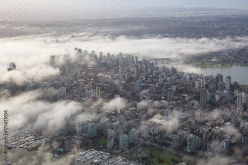 Aerial view of Downtown Vancouver, British Columbia, Canada, covered in clouds. Taken during a foggy winter sunrise.