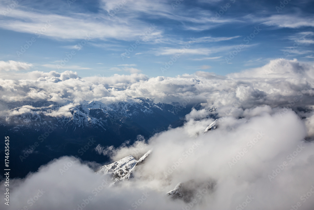 Spectacular aerial landscape view of the mountains covered by the layer of cumulus clouds. Taken near Sunshine Coast, British Columbia, Canada. Spectacular aerial landscape view of the mountains covered by the layer of cumulus clouds. Taken near Sunshine Coast, British Columbia, Canada.