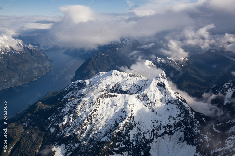 Diadem Mountain with Jervis Inlet in background, North of Sunshine Coast, British Columbia, Canada. Taken from an Aerial Perspective during a cloudy evening.