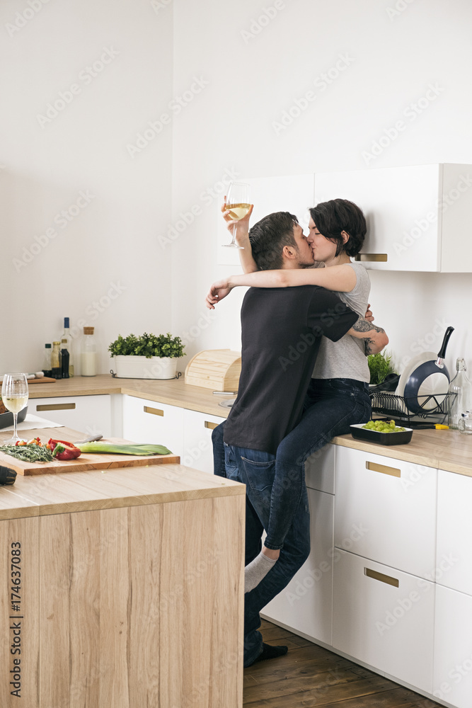 Couple kissing in the kitchen Couple kissing in the kitchen