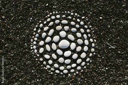 white stones arranged in circular pattern on beach