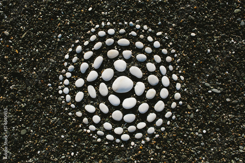 white stones arranged in circular pattern on beach photo