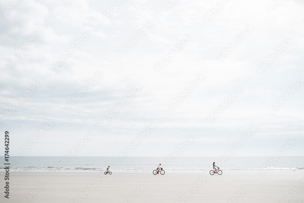 three kids riding their bikes on the beach three kids riding their bikes on the beach