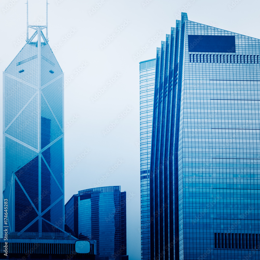 Naklejka premium architectural complex against sky in downtown hong kong,china.