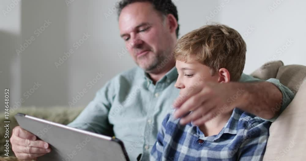 Close-up Father and Son looking at a digital tablet Close-up Father and Son looking at a digital tablet