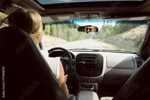 Rear view of woman driving car