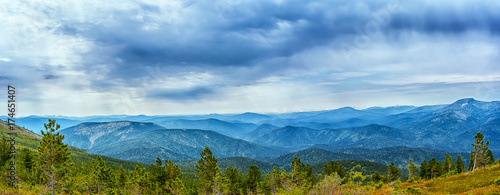 Cloudy sky over blue mountain range