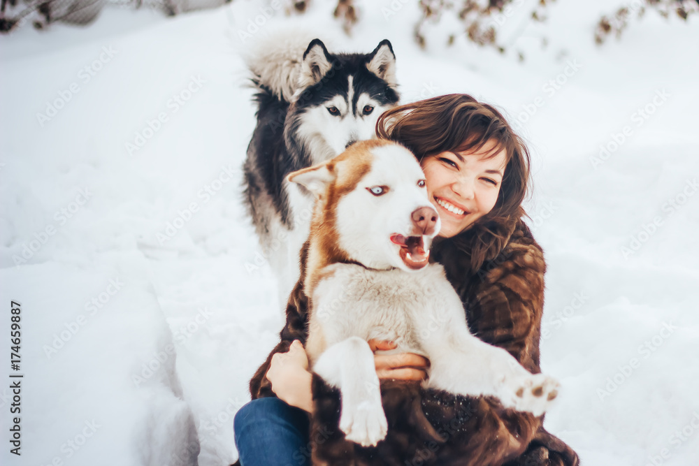 Young girl hugging a dog Husky winter Young girl hugging a dog Husky winter