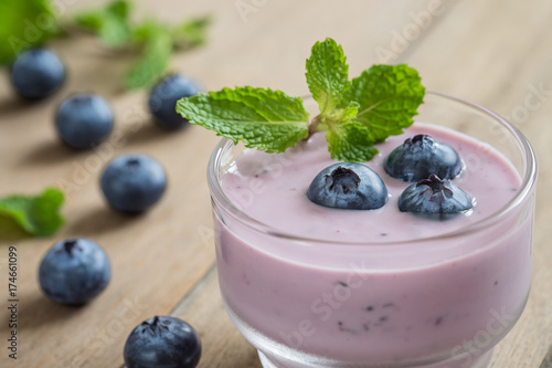 Yogurt with fresh blueberries in glass