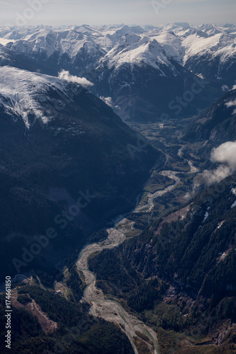 Aerial landscape view of the river in the valley between the mountains. Taken far remote North West from Vancouver, British Columbia, Canada.