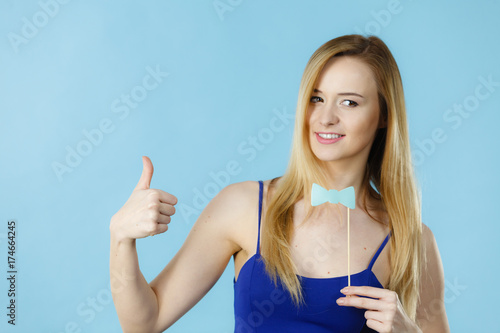 Woman holding carnival accessoies on stick photo