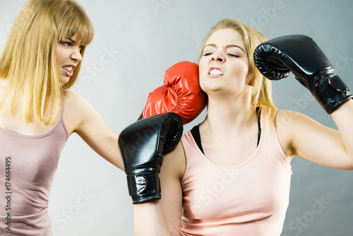 Two agressive women having boxing fight
