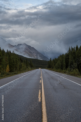 Road with mountains in the background. Taken in Icefields Pkwy, Banff National Park, Alberta, Canada.