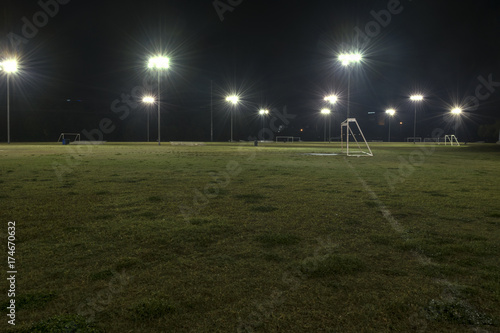 Empty athletic soccer fields at night with lights on