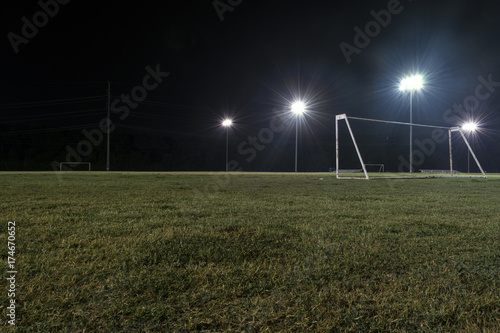 Low angle night photo of goal on empty soccer field