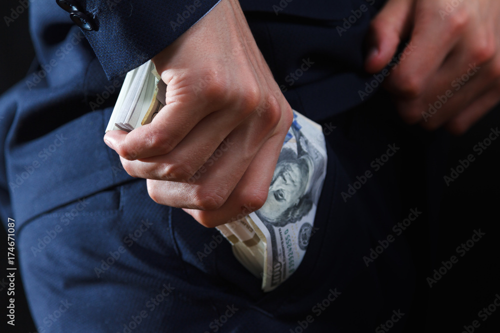 Concept for corruption, bankruptcy, bail, crime, bribing, fraud. Bundle of dollar cash in hand.
