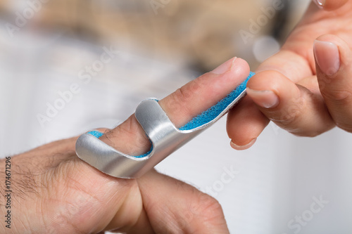 Physician Holding Person s Finger With Brace