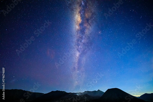 Bromo volcano with milky way, the moon and sand strom Tengger Semeru national park, East Java, Indonesia