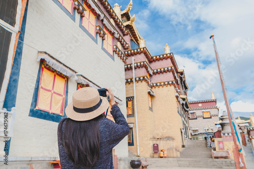 Female tourists are traveling in Little Potala Palace Lamasery, The famous temple in shangri-la , yunnan , china.