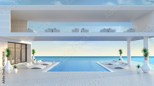 A modern house,Beach lounge ,sun loungers on Sunbathing deck and private swimming pool at luxury villa/3d rendering photo