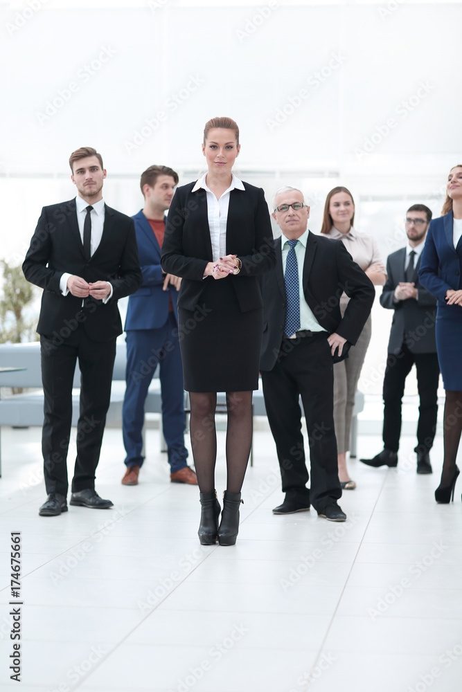 confident business woman standing in front of his business team. confident business woman standing in front of his business team.