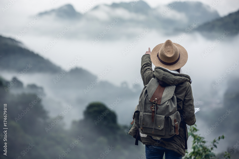 Naklejka premium Happy woman tourist to travel in wild trip hiking during vacation.Travel concept.