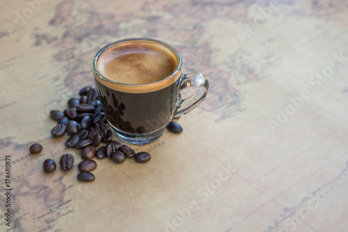 Black coffee with bean on map background