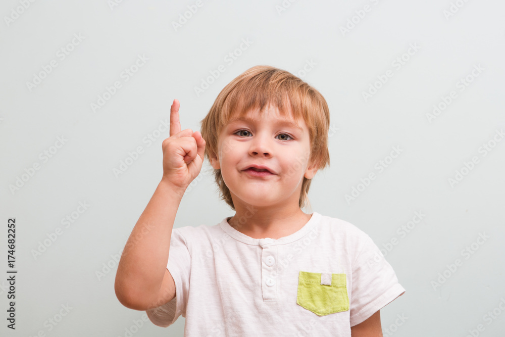 Cheerful smiling little boy having an idea. Cheerful smiling little boy having an idea.