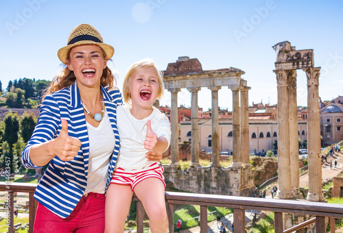 smiling mother and child tourists in Rome showing thumbs up