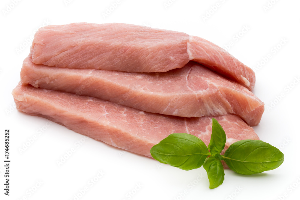 Fresh pork fillet with basil on a white background. Fresh pork fillet with basil on a white background.