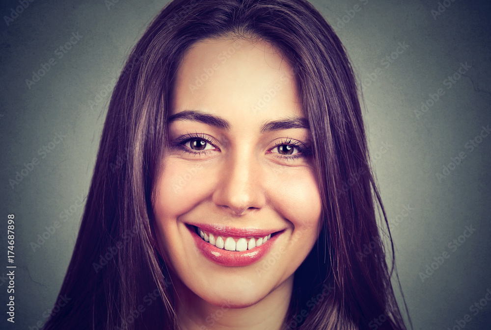 Fototapeta premium Portrait of a beautiful smiling woman with perfect white teeth