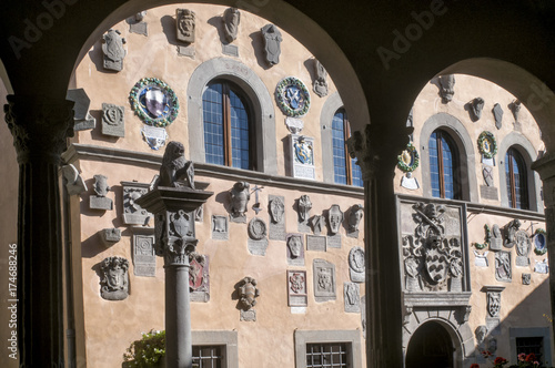 The stunning Palazzo dei Capitani della Montagna in Cutigliano, Pistoia, Italy, framed in the arches of the loggia in front photo