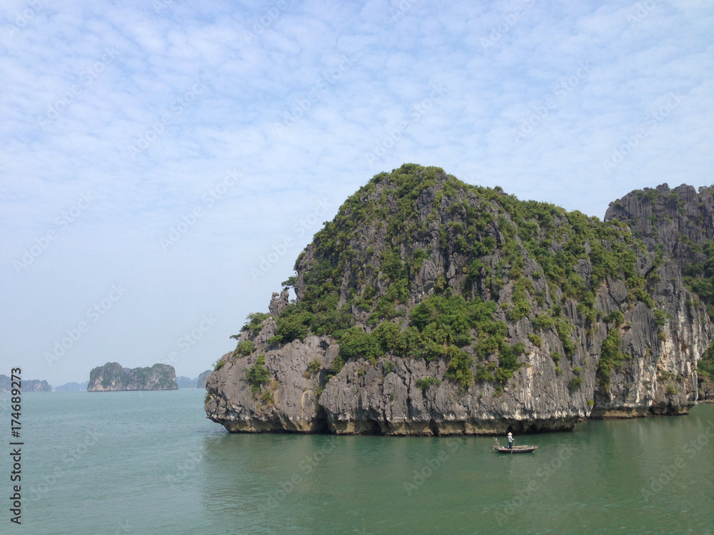 Naklejka premium Vietnamese at a boat in Ha Long Bay in Vietnam