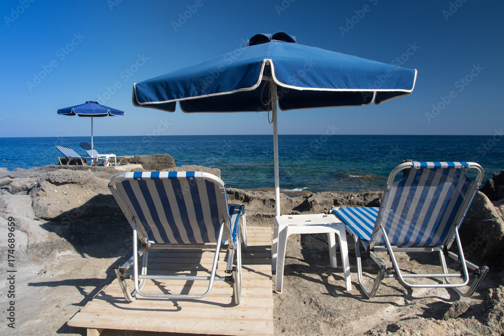 Sunshade and  sun beds on  Kalithea beach, Rhodes