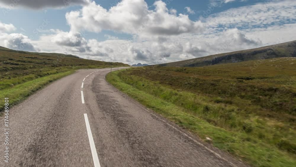 POV shot from a camera attached to the front of a vehicle driving through beautiful empty roads in the scottish highlands POV shot from a camera attached to the front of a vehicle driving through beautiful empty roads in the scottish highlands