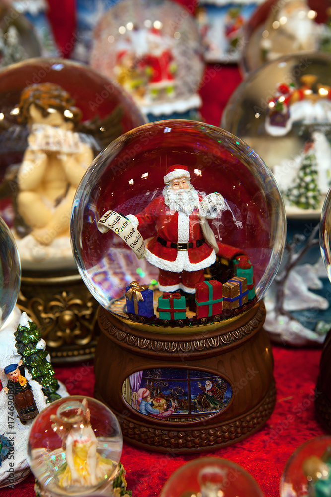 Christmas ball with Santa Claus holding names list and colorful presents, vertical