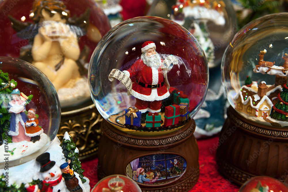 Christmas ball with Santa Claus holding names list and colorful presents