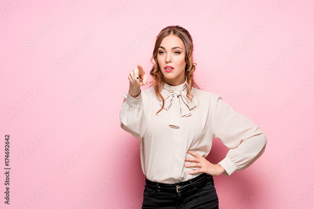 The serious frustrated young beautiful business woman on pink background The serious frustrated young beautiful business woman on pink background