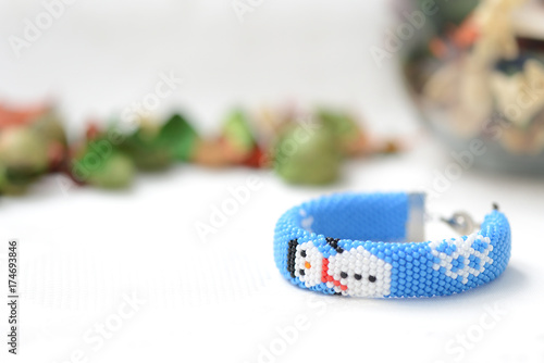 Blue Christmas bracelet with image of snowman close up