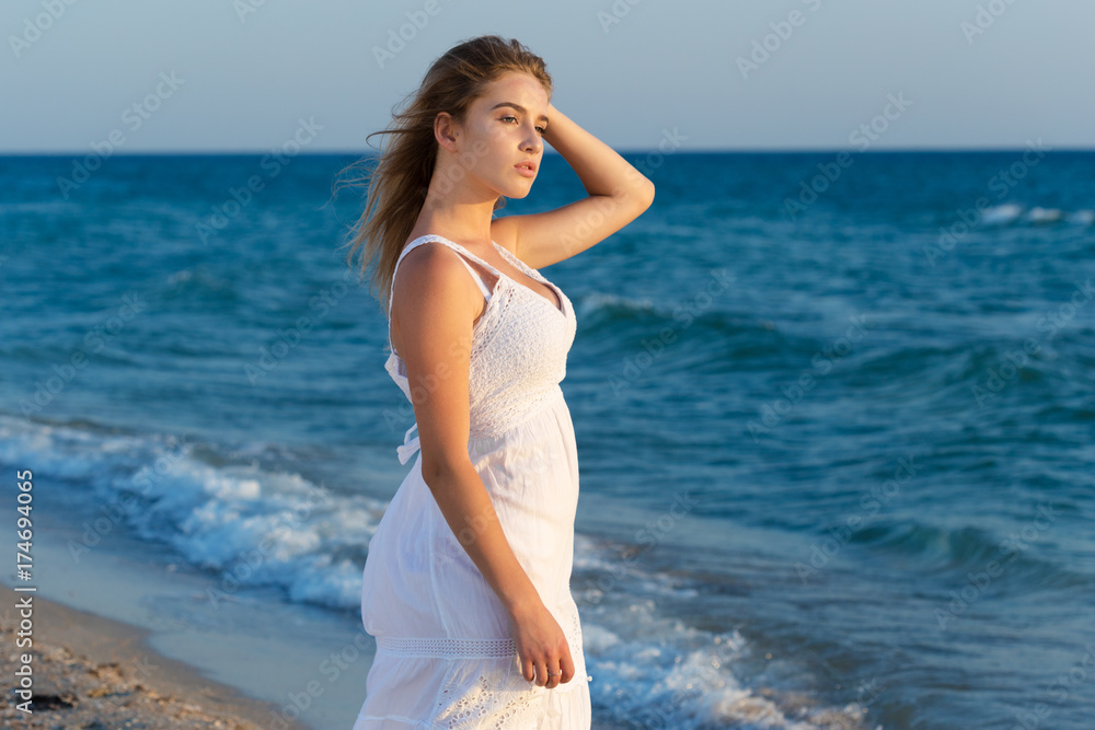 Woman in a white dress on beach