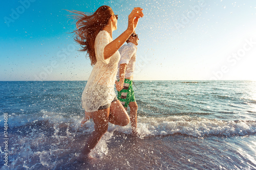 Happy young couple enjoying the sea photo