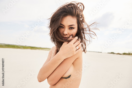 Sensual portait of an asian girl with hair waving photo