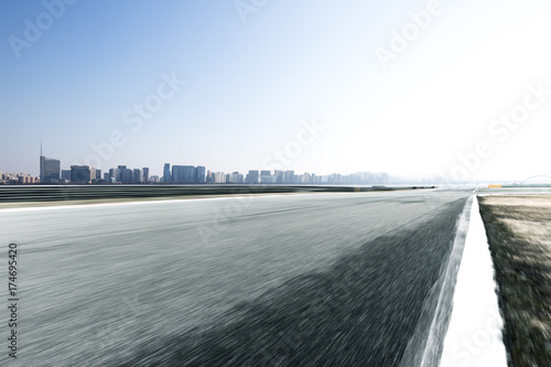 emtpy asphalt road with cityscape of modern city © zhu difeng