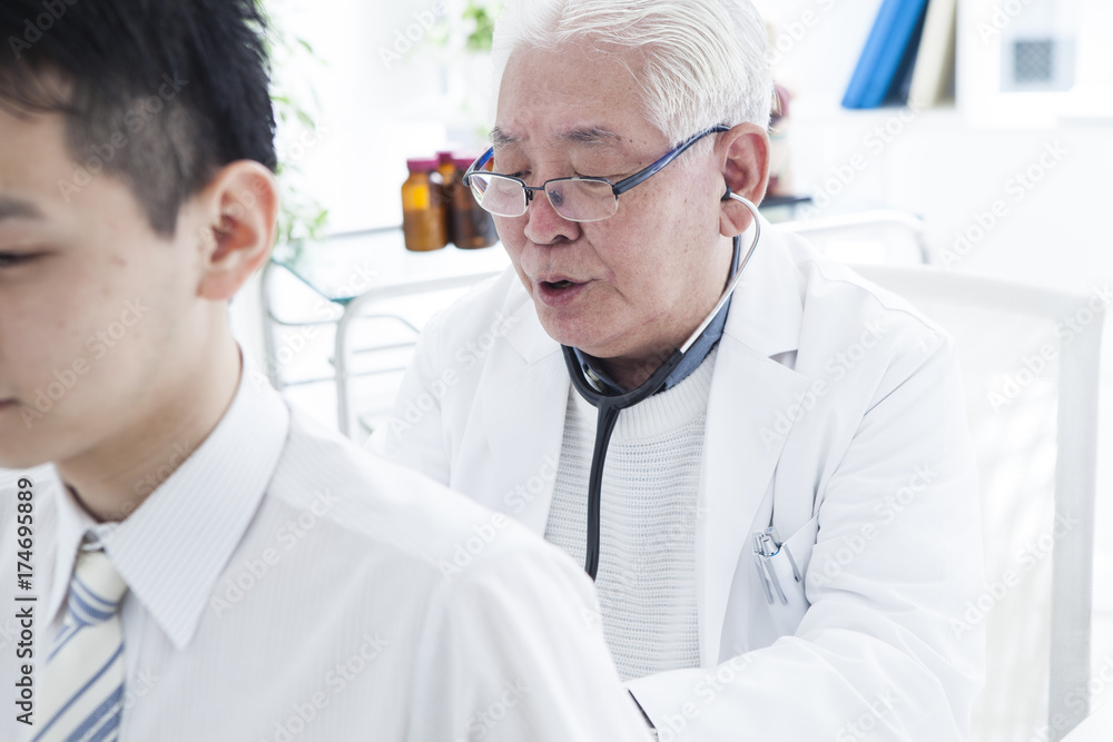 The doctor is palpating the patient's back The doctor is palpating the patient's back
