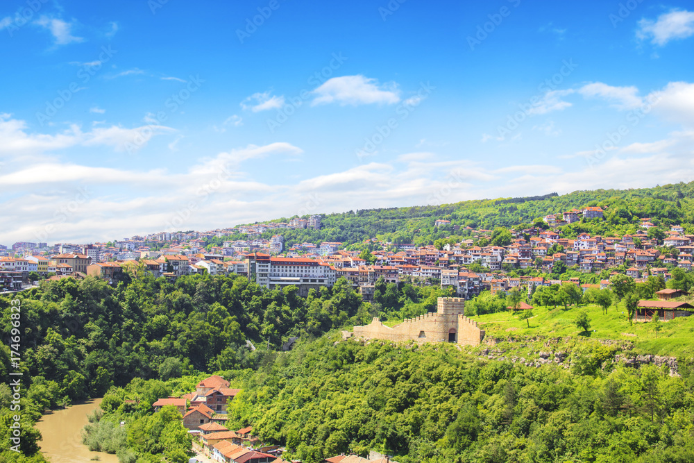 A beautiful view of the Tsarevets fortress among the green hills in Veliko Tarnovo, Bulgaria