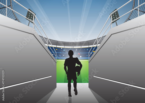 Football Player with a walking on a stadium tunnel