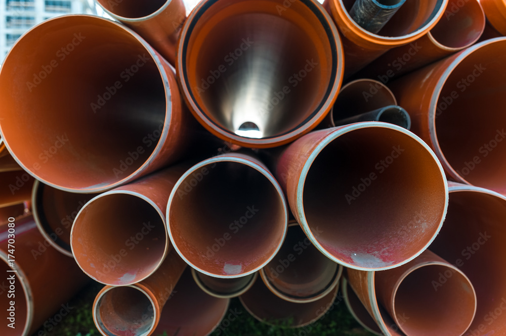 Stack of pvc pipes on a construction site.