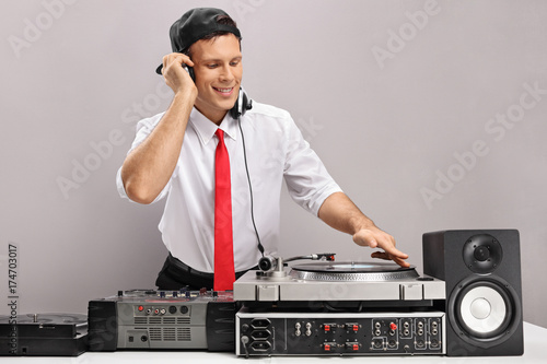 Formally dressed guy playing music on a turntable