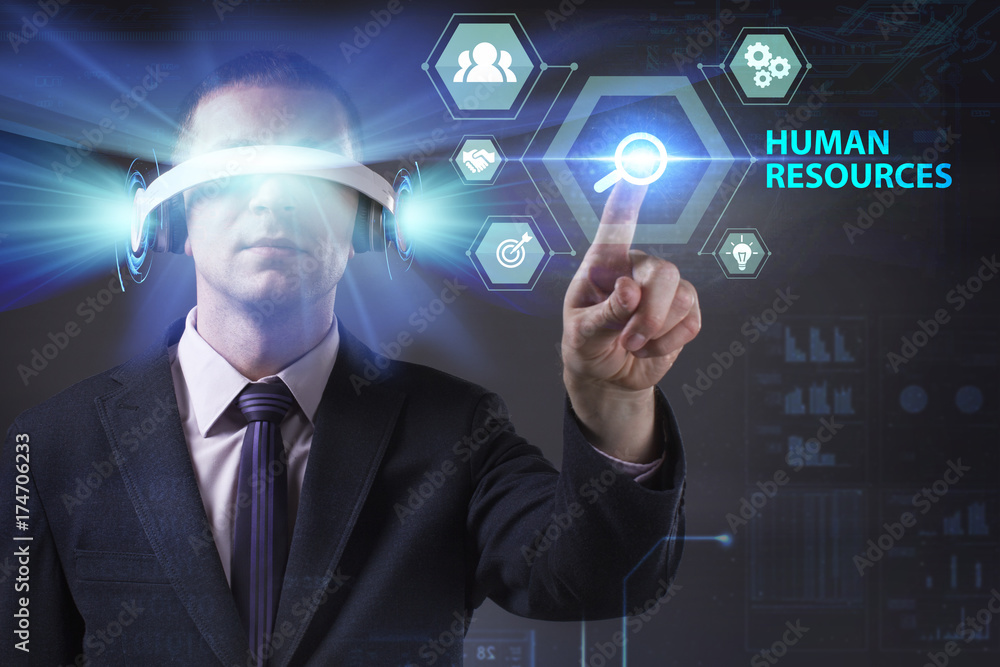 Fototapeta premium Business, Technology, Internet and network concept. Young businessman working in virtual reality glasses sees the inscription: Human resources