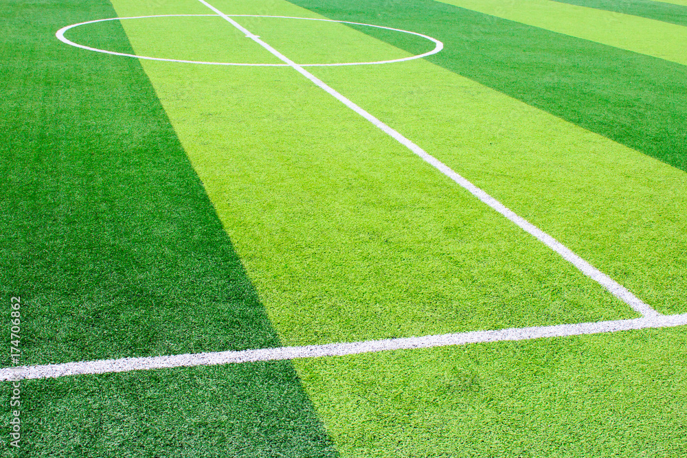 Photo of a green synthetic grass sports field with white line shot from above
